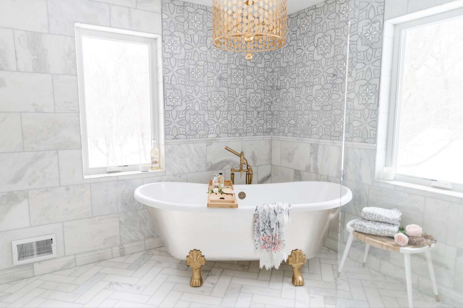 gray and white bathroom with gold accents and mixed tile