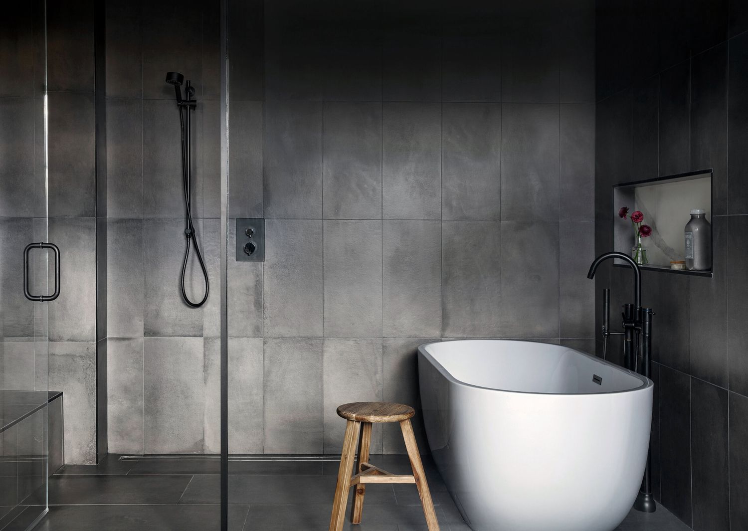 dark gray bathroom with white bathtub