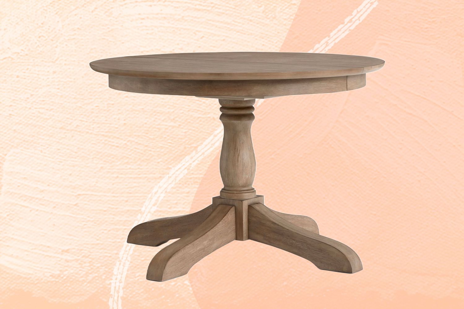 Pottery Barn Owen Round Pedestal Extending Dining Table sur fond rose